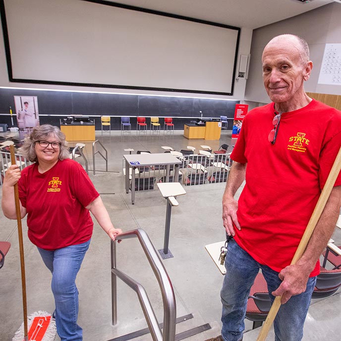 Custodians Eric Smay and Beth Paulsen pose in Troxel Hall.