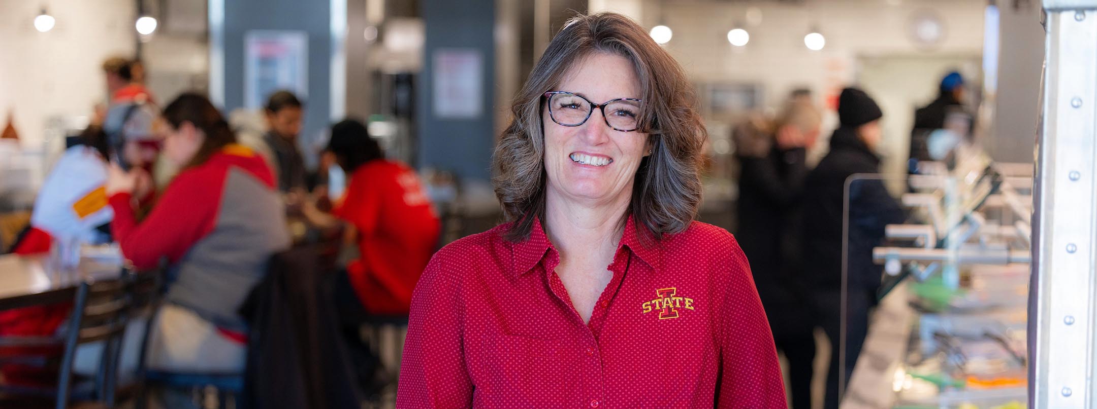 Informal portrait of Tori Tafoya in a dining center.